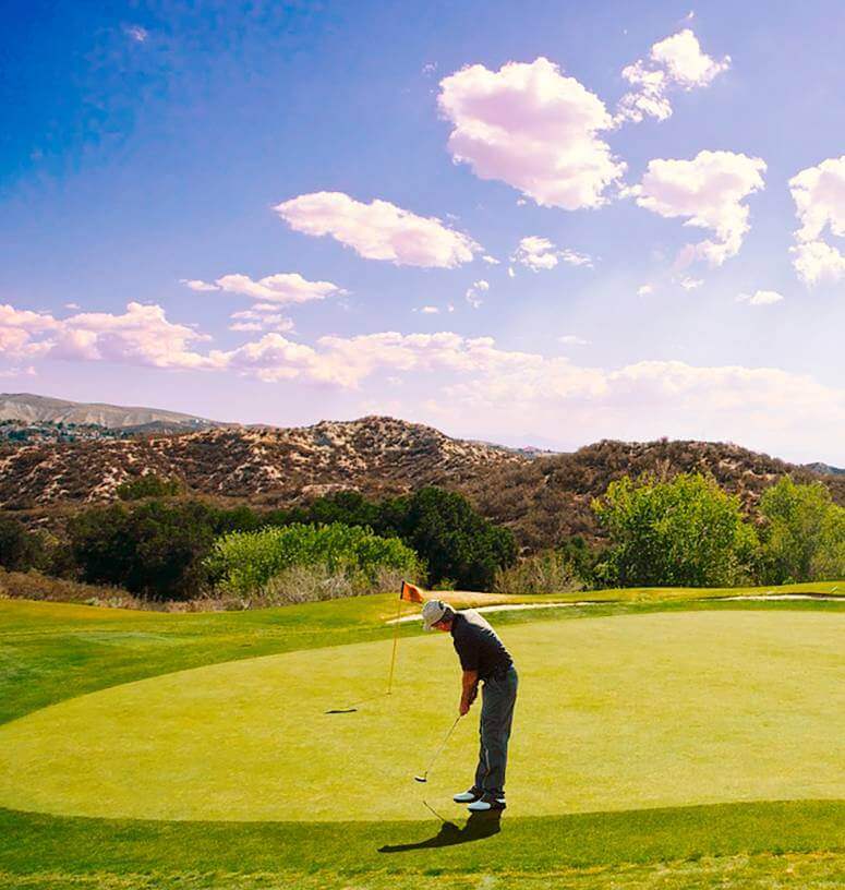 Man plays golf at Copper Sun course under clear sky